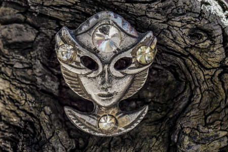 Old alien face mask on old wood closeupの写真素材