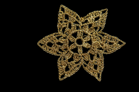 Golden Christmas tree snowflake isolated on black backgroundの写真素材