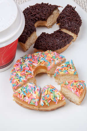 Colorful and chocolate Donuts with coffee in verticalの写真素材