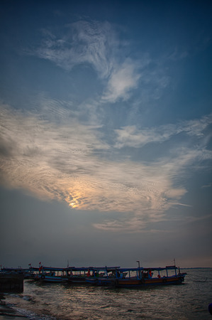 Sunset on the beach HDR with old boatの写真素材