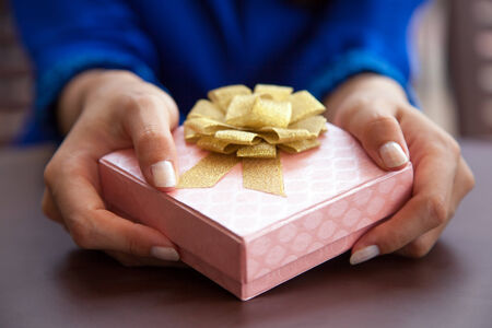 Woman giving gift box presentの写真素材
