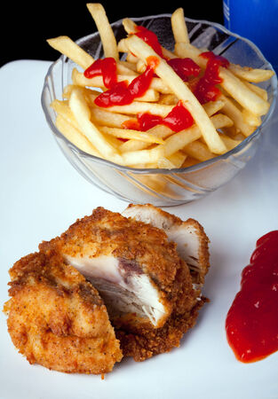 Fried Chicken with potatoes and chili sauce verticalの写真素材