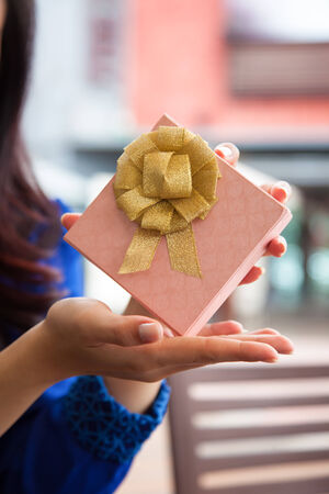 Woman holding gift box presentの写真素材