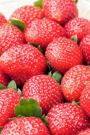 Lots of fresh strawberry fruits verticalの写真素材