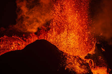 Lava shoots up as it erupts from the crater of the volcanic eruption in Iceland. Details from the crater of the Fagradalsfjall volcano. Volcano on the Reykjanes peninsula in the GeoParkの写真素材