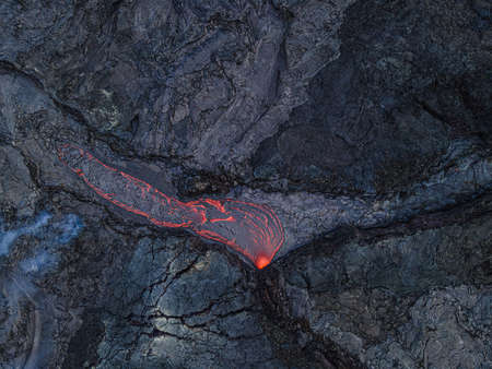 viewed from above on red-orange lava flow on cooled lava after volcanic eruption on the Reykjanes peninsula. Area around the Fagradalsfjall volcano in Iceland from GeoParkの写真素材