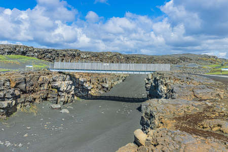 Landscape on Iceland of Reykjanes Peninsula. Metal bridge over the North American and Eurasian...