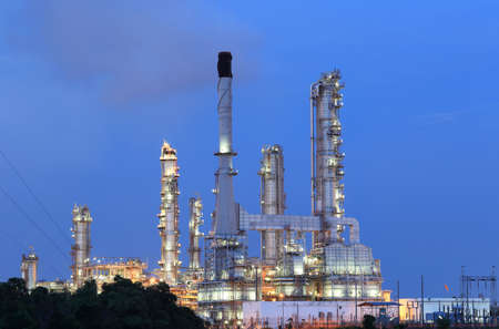 scenic of petrochemical oil refinery plant shines at night, closeup