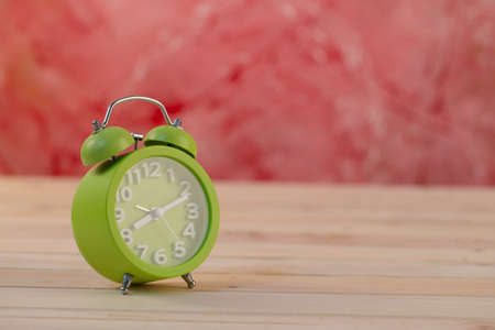 Vintage clock on wooden tableの写真素材