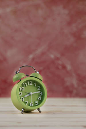 Vintage clock on wooden table
