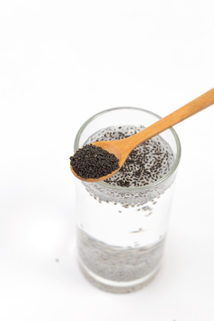 Glass of chia seeds soaking in water isolated on whiteの写真素材