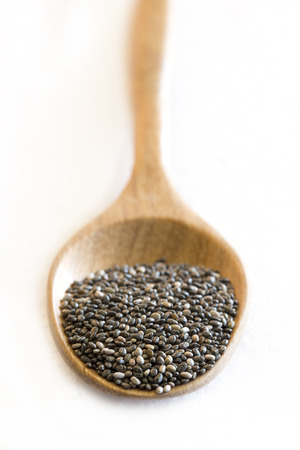 chia seeds in a wooden spoon on a white background.の写真素材