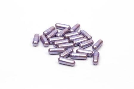 Supplement capsule purple on white background.の写真素材