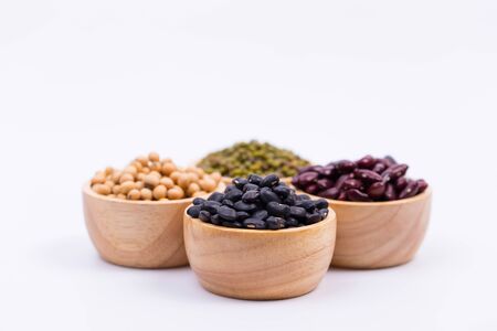 Four types of dry beans in the wooden bowlの写真素材
