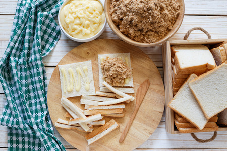 Sandwich shredded pork in salad dressing on wooden table.