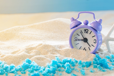 Alarm clock on the sand