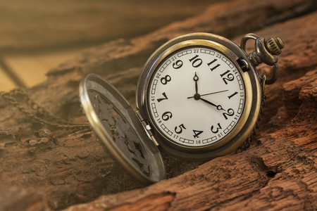 Vintage pocket watch on old wood