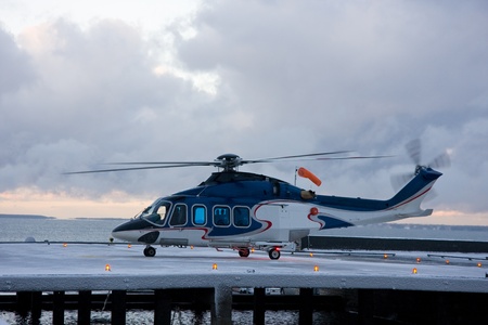 Passenger helicopter in the snow blizzard taking off from the platformのeditorial素材