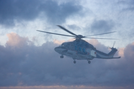 Passenger helicopter in the snow blizzard taking off from the platform at bad snow storm weatherの写真素材