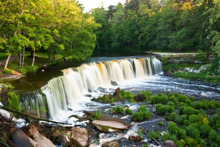 Beautiful large waterfull surrounded by green forestの写真素材