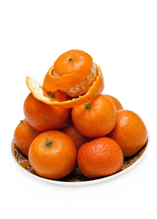 An isolated picture of mandarins stowed to heap on a plate の写真素材