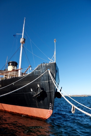 ship fore with ropes attached to quayの写真素材