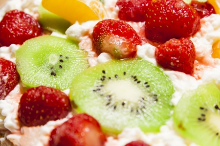 Dessert with fresh fruits such as strawberries, kiwi and mandarin and whipped creamの写真素材