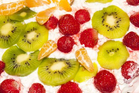 Dessert with fresh fruits such as strawberries, kiwi and mandarin and whipped creamの写真素材
