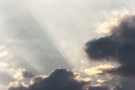 Sunrays in cloudy skyの写真素材