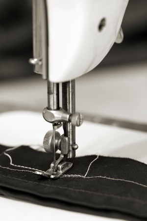 Closeup of a needle of a sewing machine that is sewing a textile or cloth or fabricの写真素材