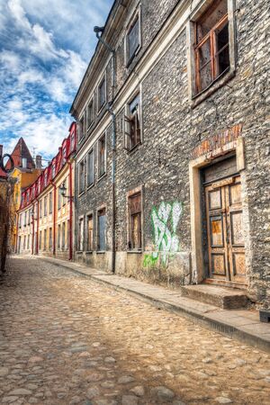 Old abandoned building with graffiti and broken windows in the Old Town of Tallinn, Estoniaの写真素材