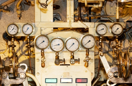 A photo of several indicators for measuring pressure of an engine  The photo is taken inside and old...