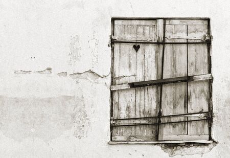 Old wood made window hatch or shutter with heart shape in itの写真素材