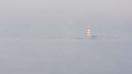 Lighthouse or beacon in mistの写真素材