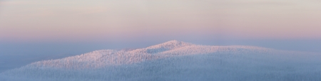 Panorama of snowy mountain in winter at sunset in Lapland, Finlandの写真素材