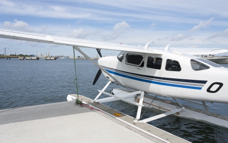 Seaplane in water parking near quay