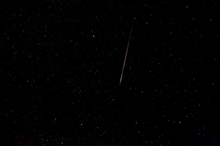 Falling star known as perseid in the skyの写真素材