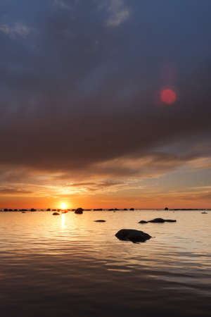 Sunset on a cloudy evening at seaの写真素材