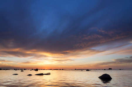 Sunset on a cloudy evening at seaの写真素材