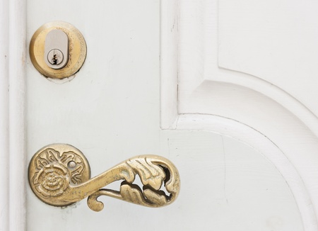 Closeup of a golden door handle on white doorの写真素材