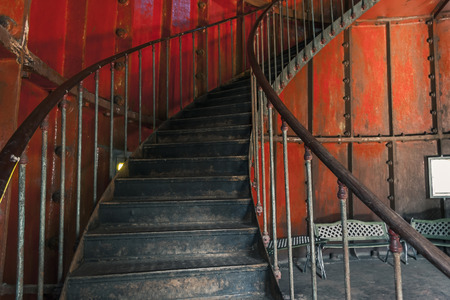 Metal screw stair inside red roomの写真素材