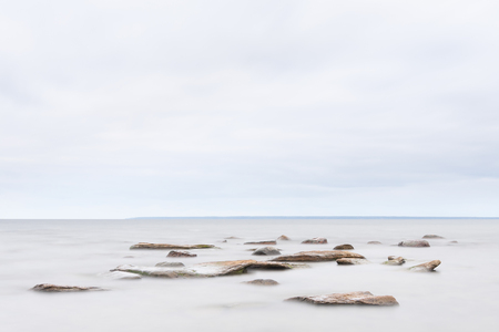 Several rocks or stones in calm seaの写真素材