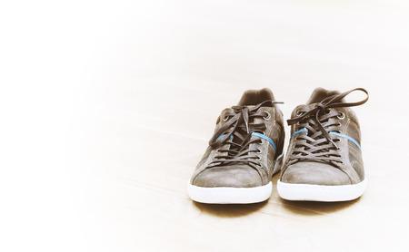 Brown shoes with white bottom on light backgroundの写真素材