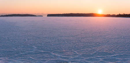 Landscape of winter sunset at frozen seaの写真素材