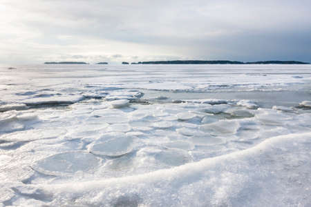 Winter landscape of frozen sea at gloomy dayの写真素材