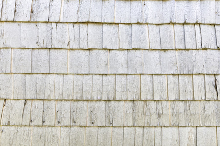 Ancient whit wooden wall made of small timber sheetsの写真素材
