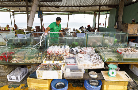NAM TIEN, VIETNAM - FEBRUARY 15, 2018: Aquariums and bowls filled with fresh seafood in a restaurant in Nam Tien, Vietnam on February 15, 2018のeditorial素材