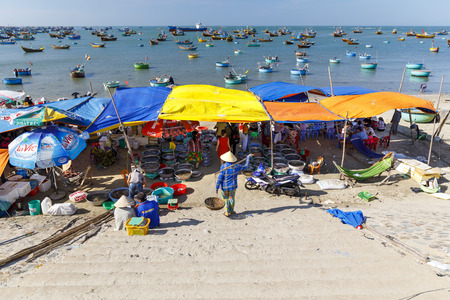 MUI NE, VIETNAM - FEBRUARY 22, 2018: Fishing harbor full of boats and a market in Mui Ne, Vietnamのeditorial素材