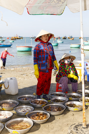 MUI NE, VIETNAM - FEBRUARY 22, 2018: Vietnamese women sell seafood fishing harbor in Mui Ne, Vietnamのeditorial素材