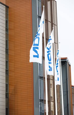 ESPOO, FINLAND - MARCH 03, 2019: White flags with Nokia company name wave in wind in Nokia campus in Espoo, Finlandのeditorial素材